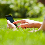 Man using mobile smart phone outdoor in summer