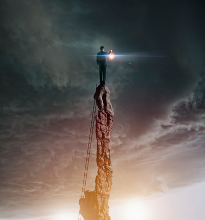 Caucasian Man With Lantern On Rocky Pillar Picture Id470621001