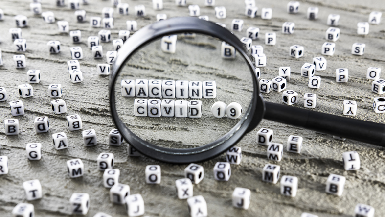 Magnifying glass covid 19 vaccine, letter cubes 