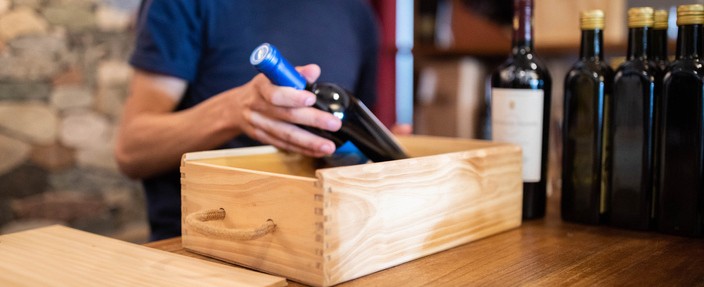 packing a wine bottle in wooden box 
