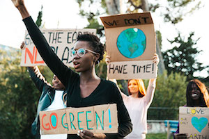 Teen with Go Green! sign