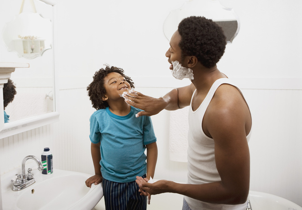 Father Applying Lather To Child's Face
