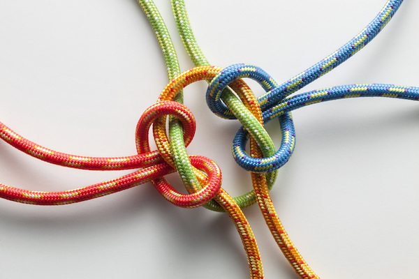 Four Twisted Ropes Of Different Colors Linked Together In The Middle