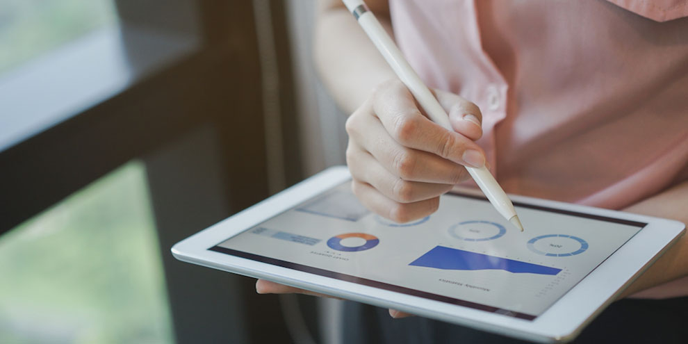 Someone On Ipad Looking At Data