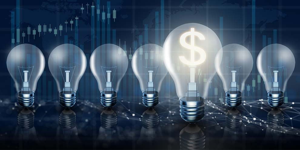 Seven Light Bulbs One On Dollar Sign In Middle Blue Hued Graphs Background