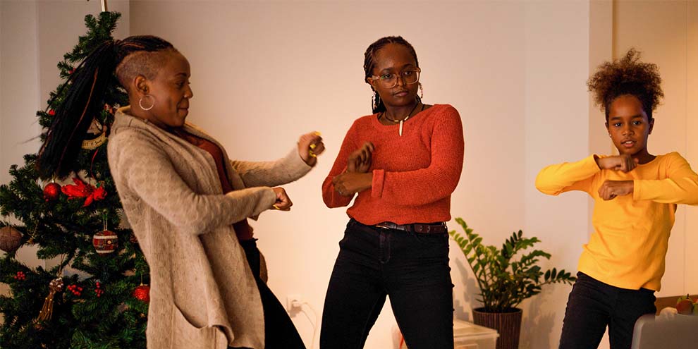 Three Women Doing Tiktok Dance Infront Christmas Tree