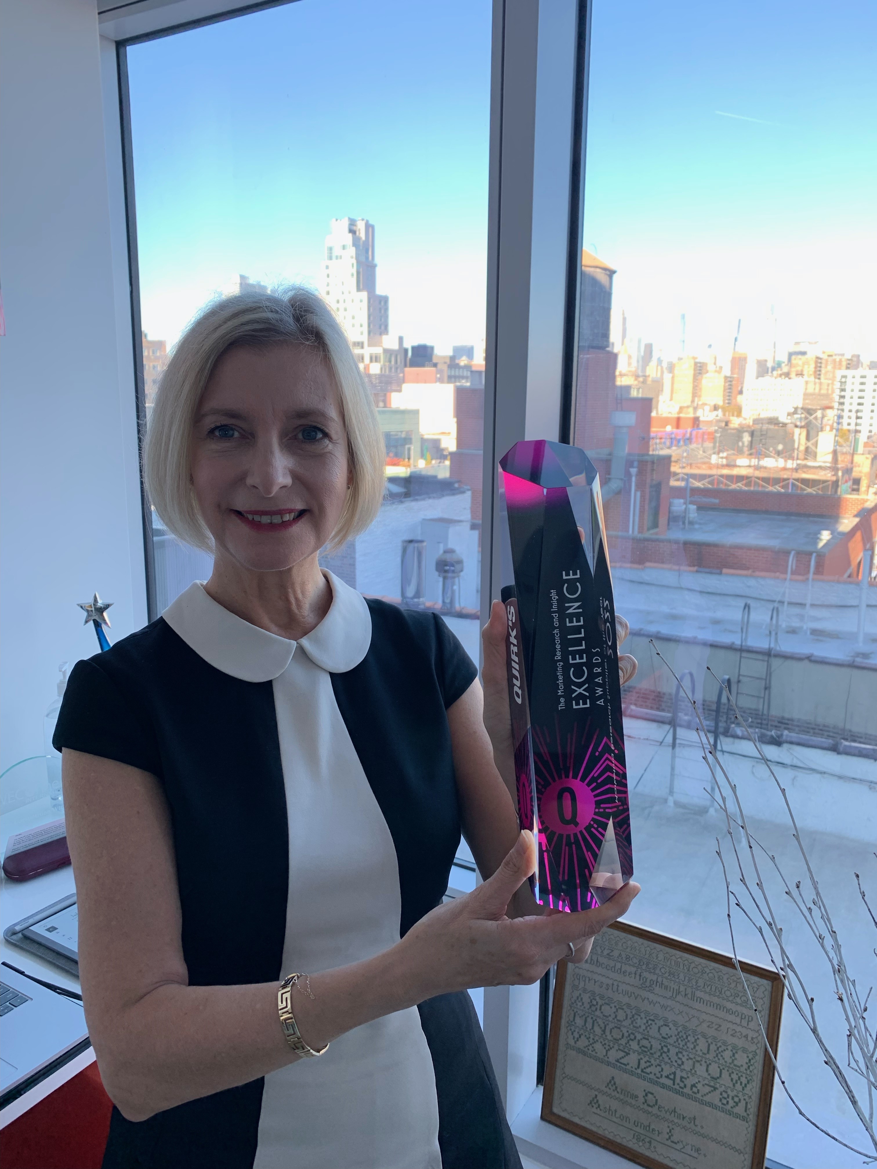 Fiona Blades, president and chief experience officer, MESH Experience holding award.