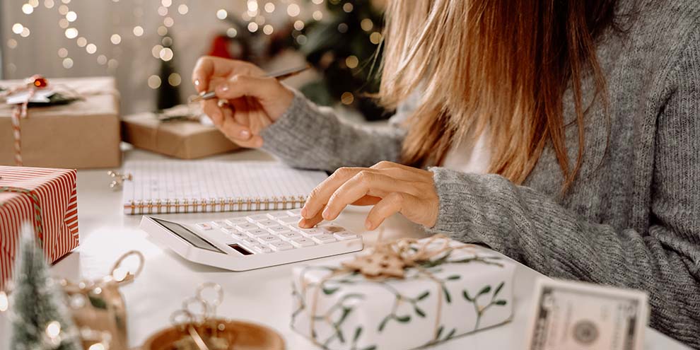 Women Counting Money Surrounded By Gifts Holiday Lights