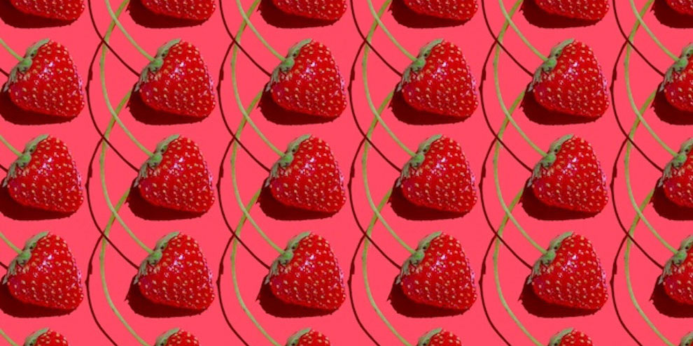 Rows of strawberries on a red background.