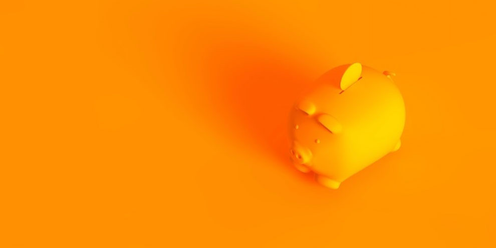 An orange piggy bank on an orange background.