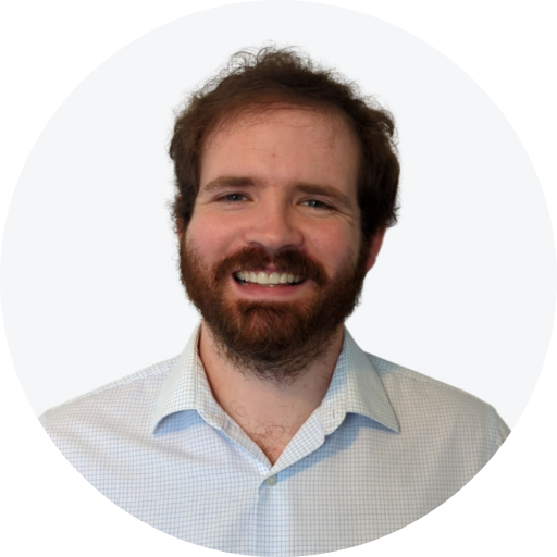 Photo of Justin Perkins smiling at the camera on a white background.