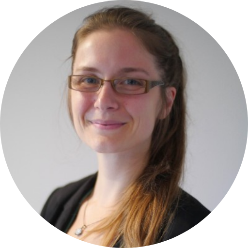 Marie Hense’s headshot on a grey background.