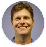 Dan Weber’s headshot with a slightly blurred background.