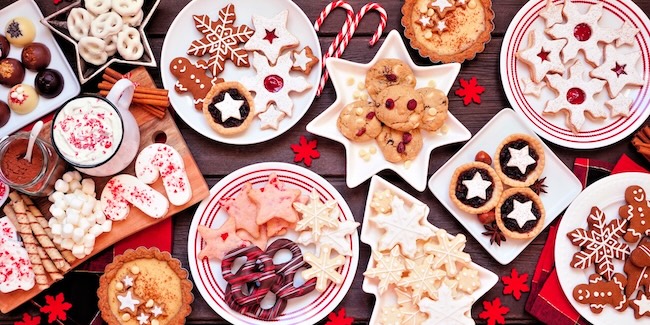 A table of holiday cookies, cakes and treats.
