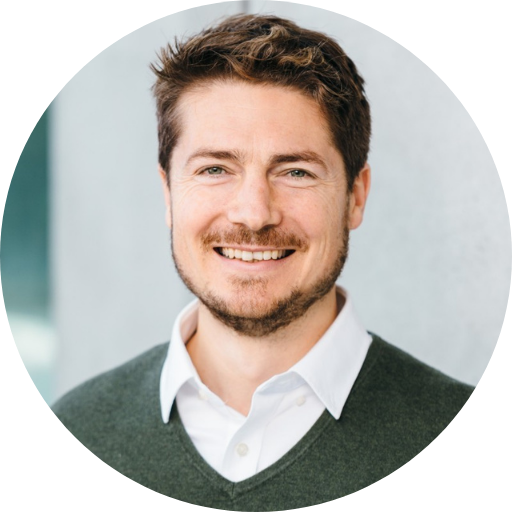 Joseph Rini’s headshot on a blurred background.