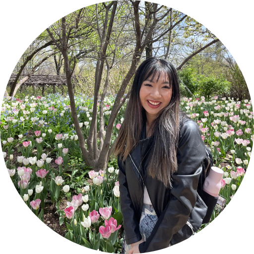 Ann Nguyen in front of a field of flowers.