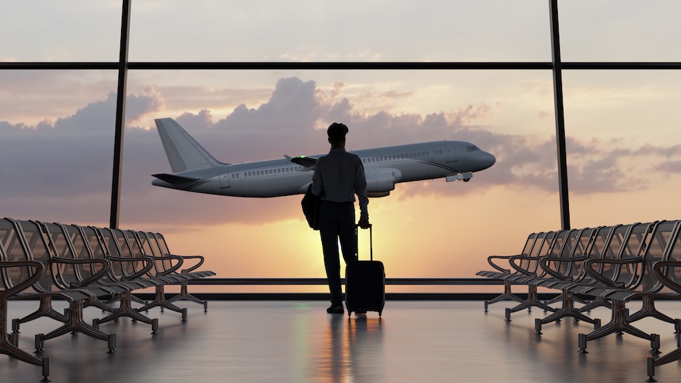 Man watching an airplane fly.